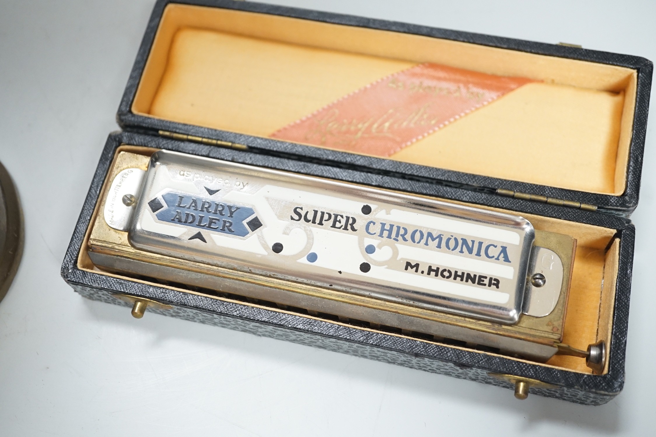 An Eccles miner’s lamp, 25cm high, together with a German harmonica